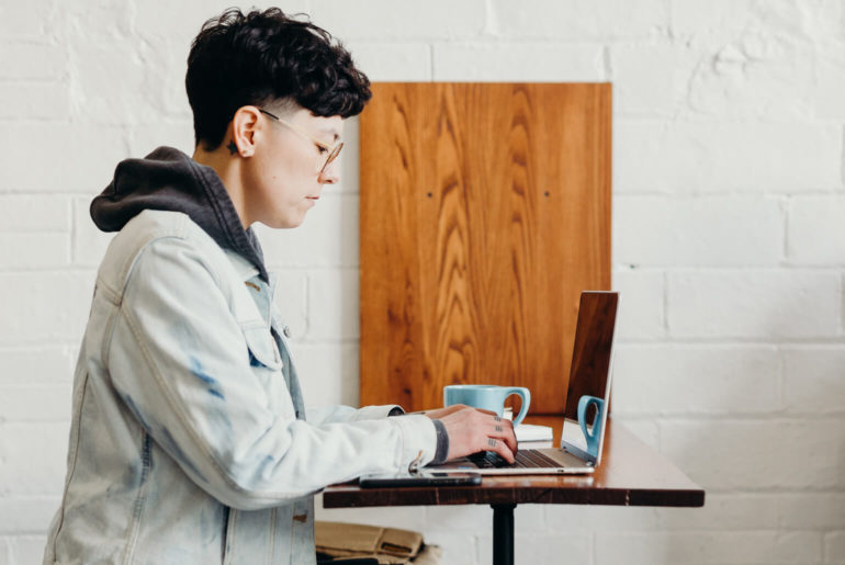 a person using a laptop on a table.