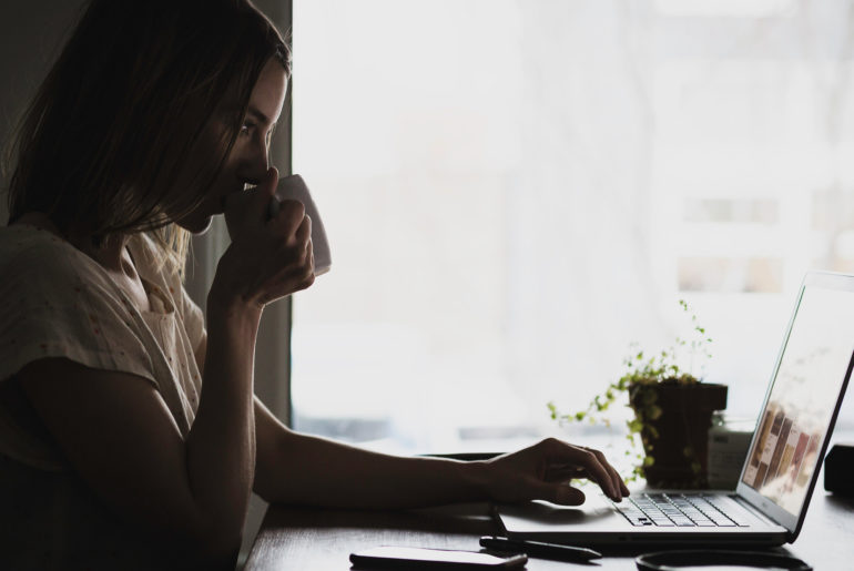A woman engaged in remote work with a laptop.