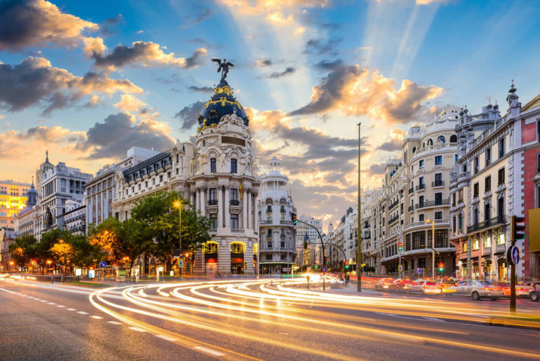 A clock tower at a city street with wanderlust vibes.