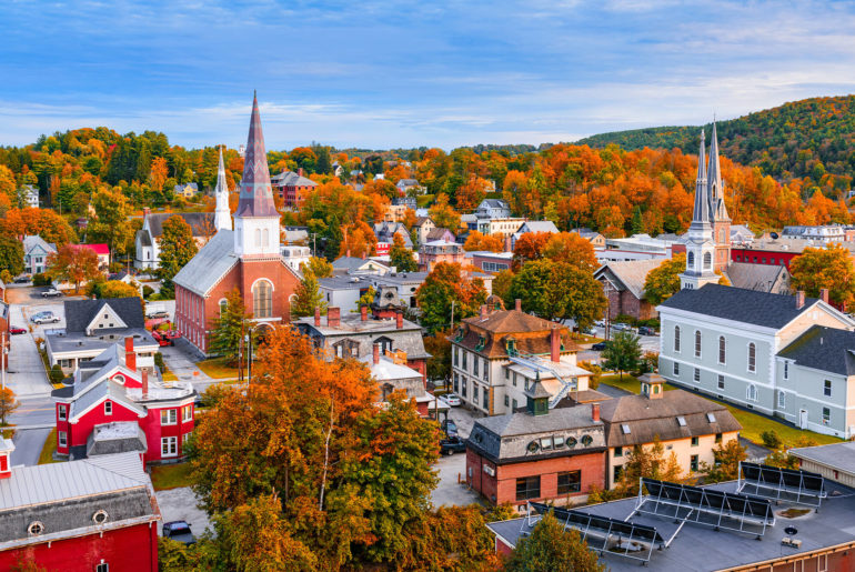 a small town with a steeple in the background.