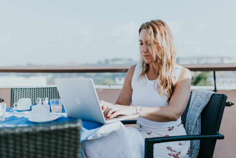 digital nomad getting work done on rooftop