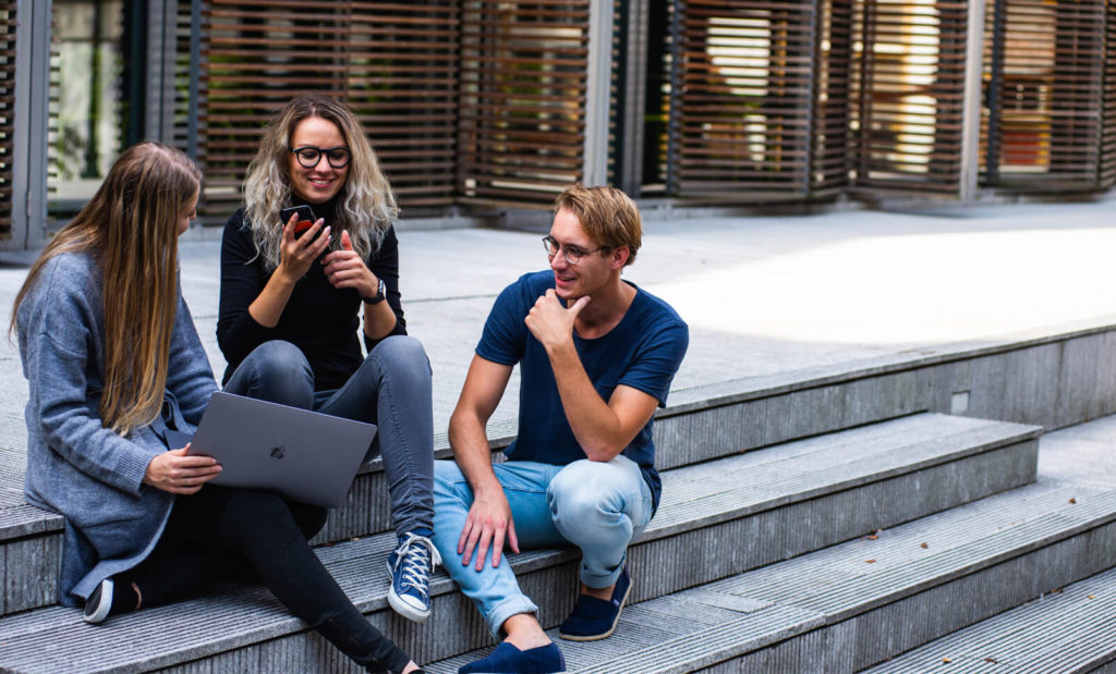 three digital nomads meeting at a community event