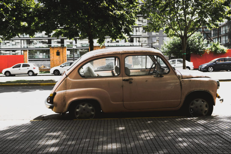 A small car parked on the side of the road in Argentina.