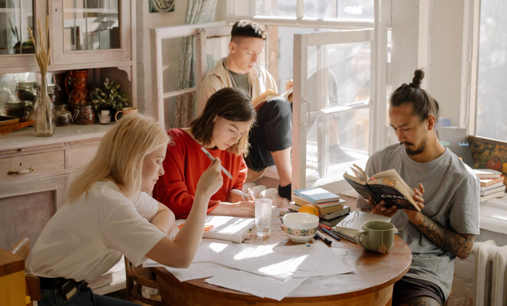 friends in a coliving together working in the kitchen