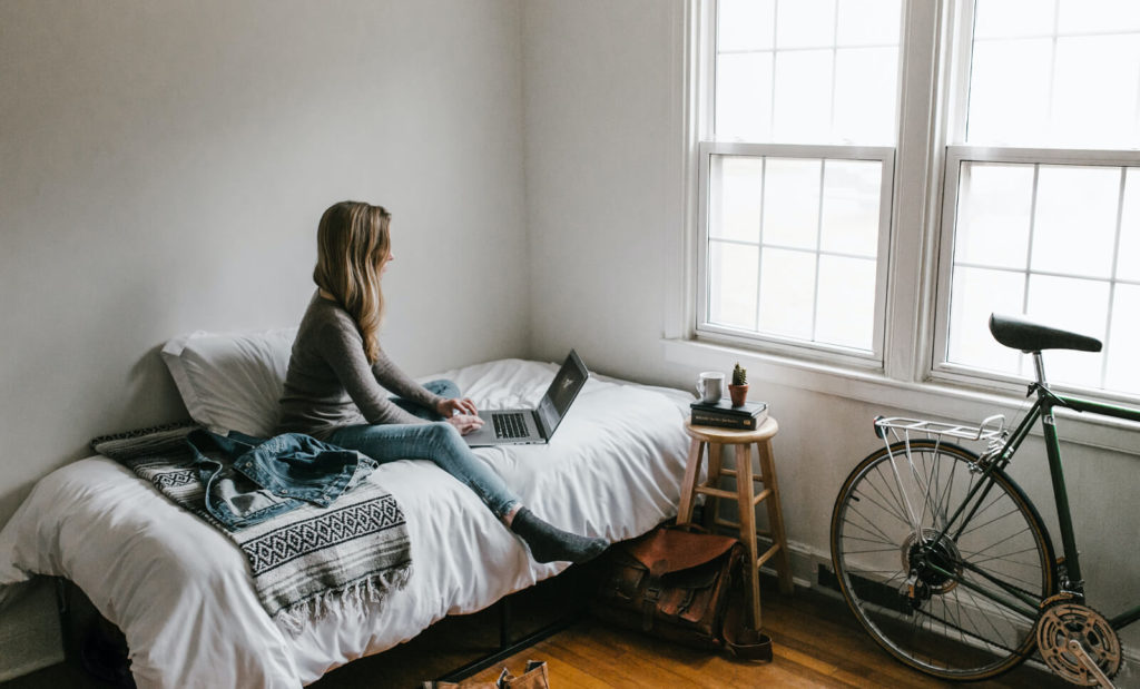 digital nomad working from her room in a coliving space