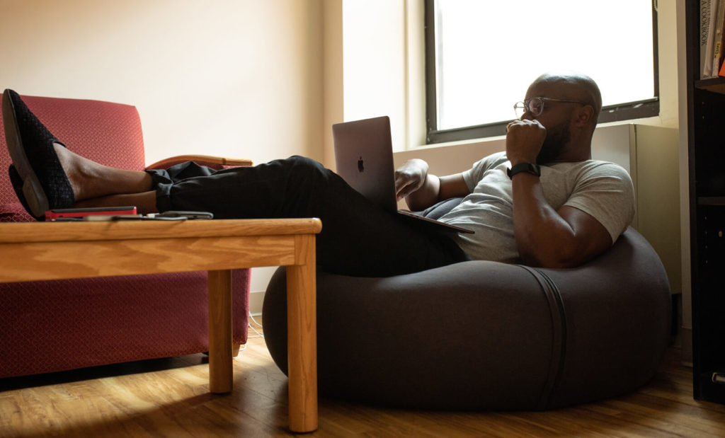 man working from a bean bag chair