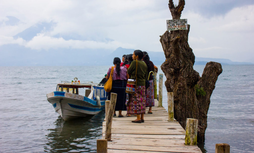 woman getting on taxi boat in panajachel 