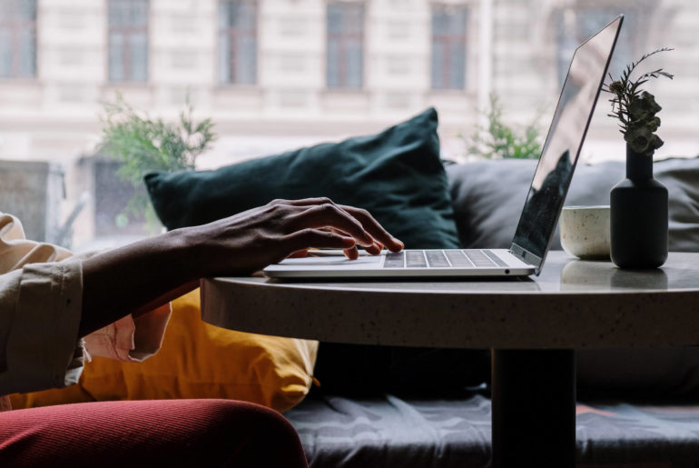 woman working on laptop in cafe