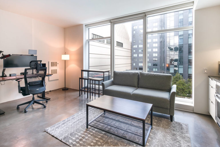 a living room filled with furniture and a flat screen tv.