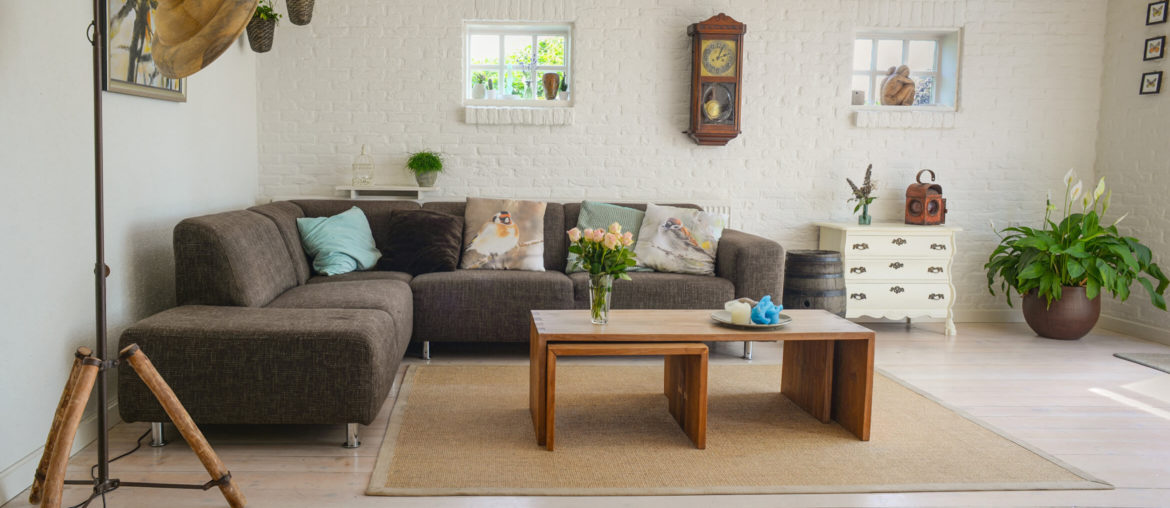 Tips for decorating a furnished apartment with a living room featuring a stylish couch and coffee table.
