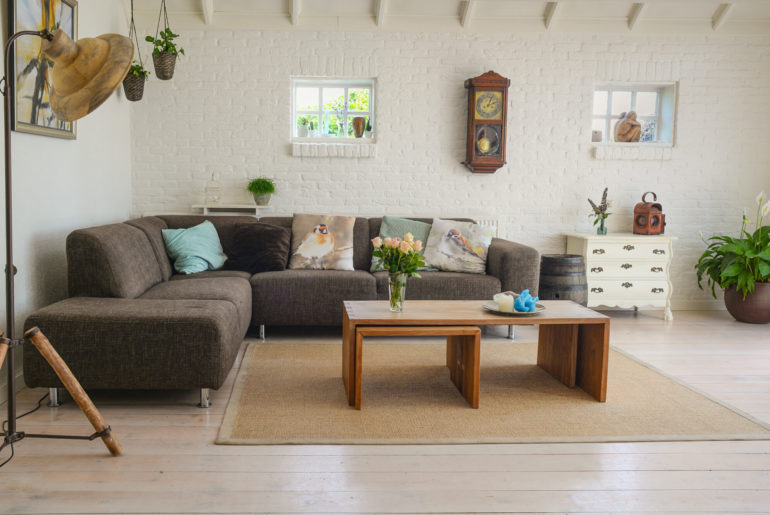 Tips for decorating a furnished apartment with a living room featuring a stylish couch and coffee table.