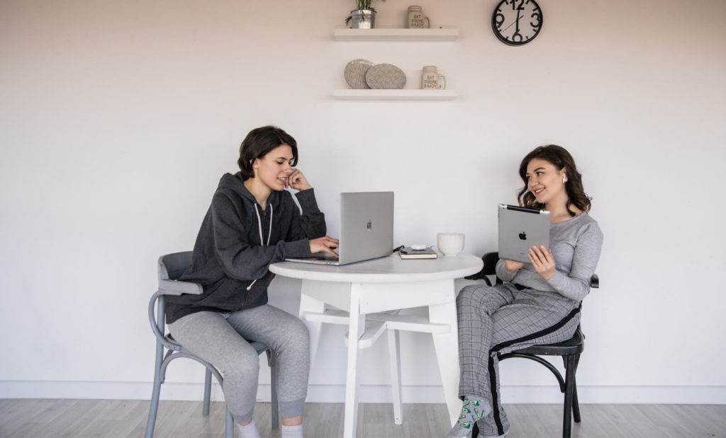 two women working with each other