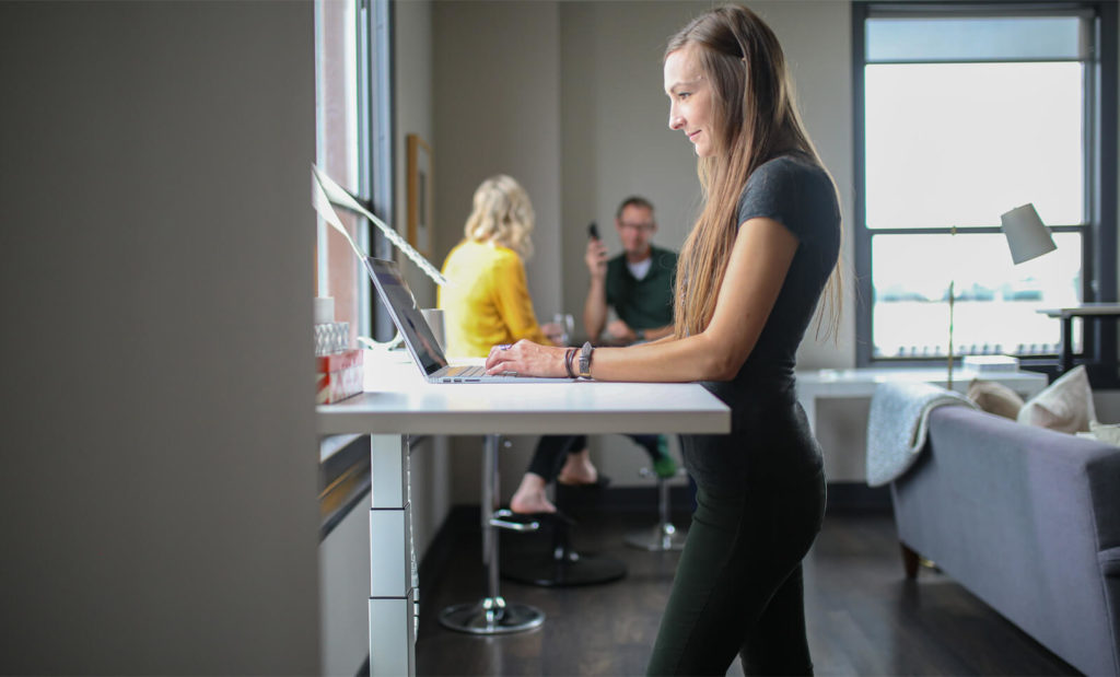 girl at a standing desk exercising