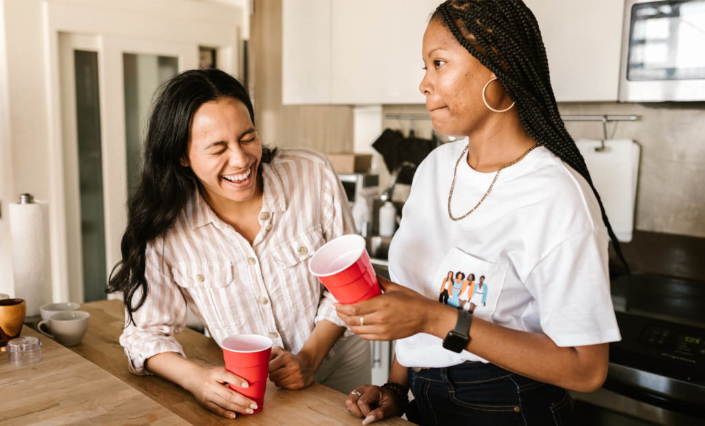 two girls drinking at a hostel