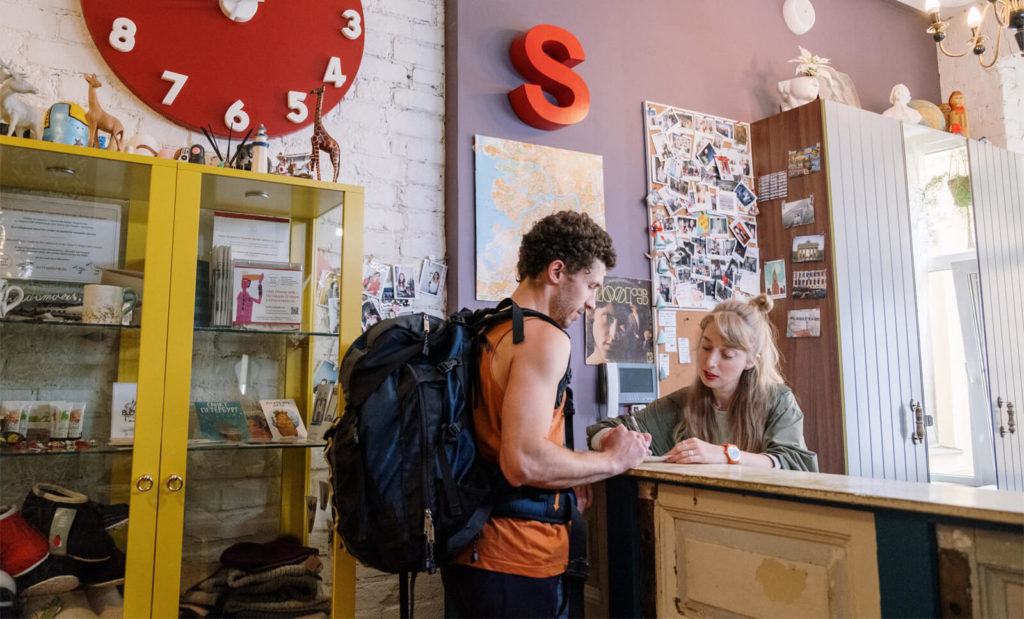 guy checking into hostel