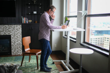 man working from a standing desk