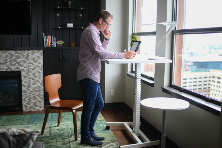 man working from a standing desk