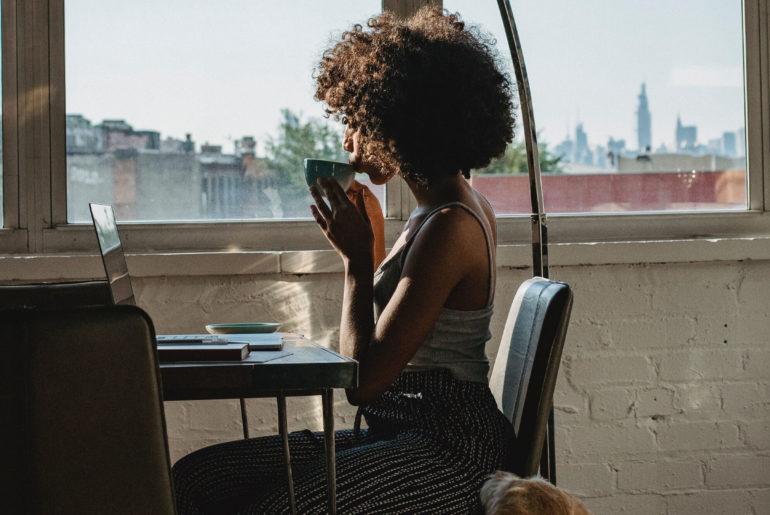 woman drinking tea as she works remotely