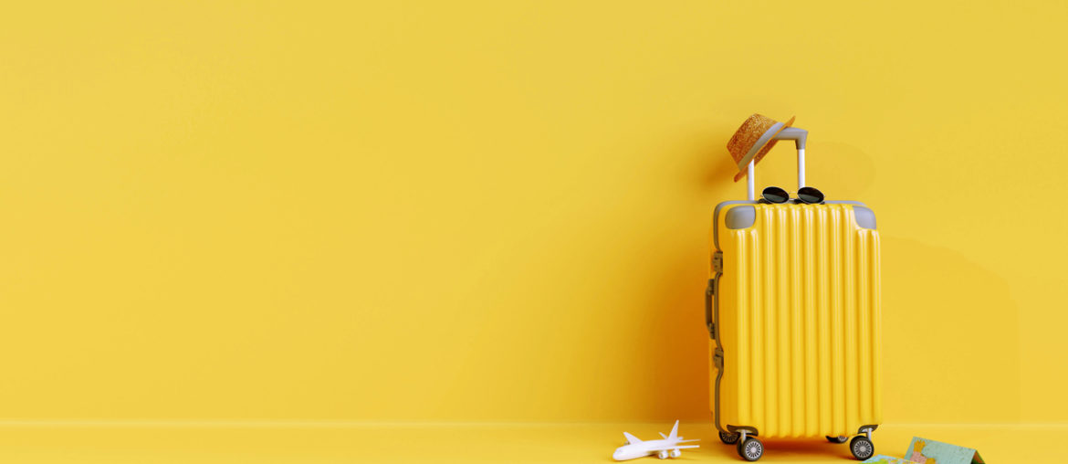 A minimalist yellow suitcase on a yellow floor.