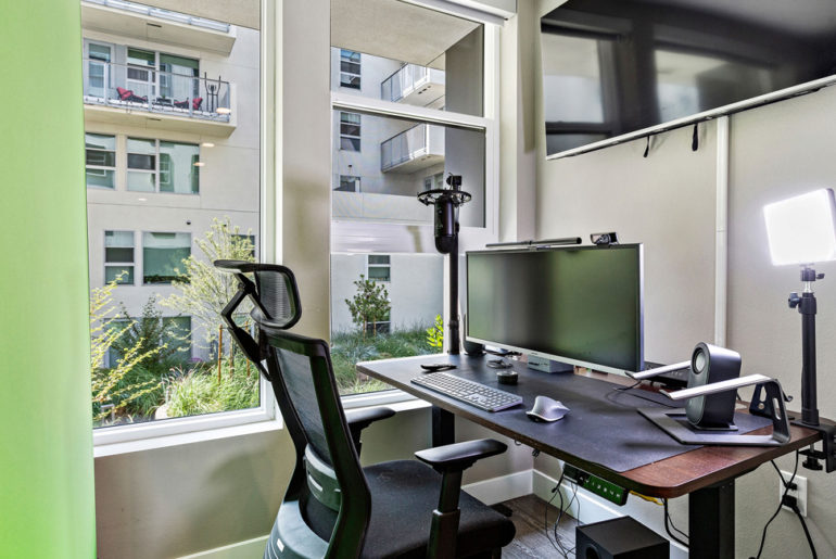 An office computer desk with a monitor and keyboard.