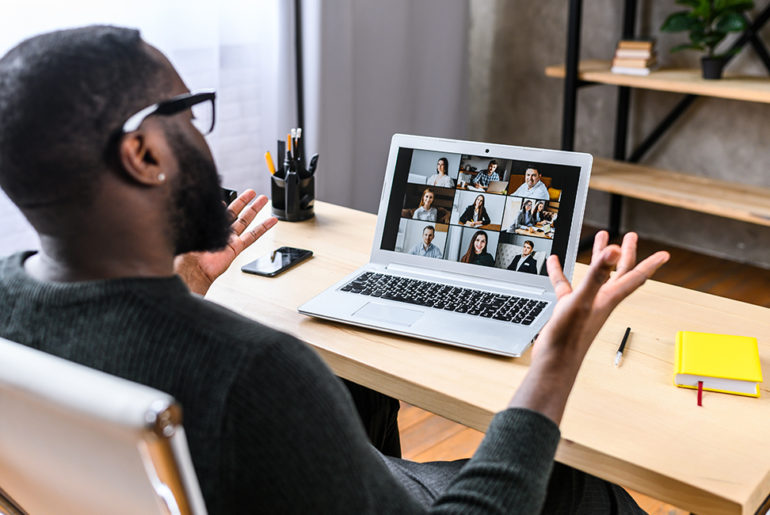 a man sitting in front of a laptop computer.