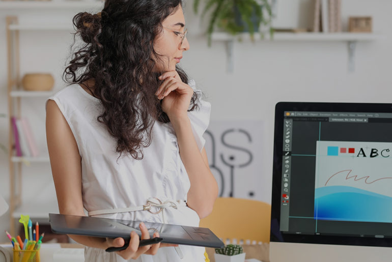 A relocating woman in front of a computer screen.