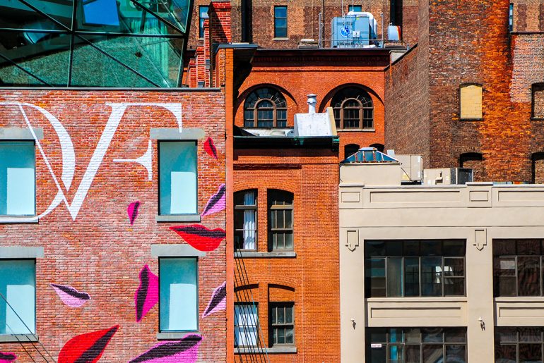 A Chelsea building with a mural on the side.