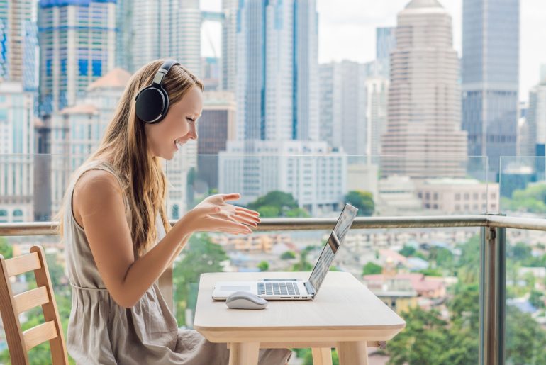 a woman working remotely on her laptop at a table.